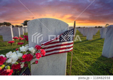 Army veteran cemetery white headstones decorated with flowers and USA flags. Tombs of retired military soldiers. Memorial Day concept Army veteran cemetery white headstones decorated with flowers and USA flags. Tombs of retired military soldiers. Memorial Day concept 118482038