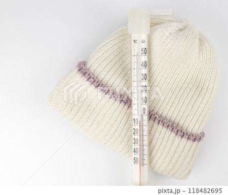 A thermometer showing the sub-zero temperature outside in celsius on a child's winter hat. The concept of a cold in winter. 118482695