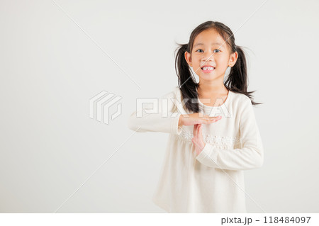 Closeup portrait young kid girl smiling making give time out gesture with hands studio shot isolated on white background, kindergarten child demonstrates break hand sign, stop time with copy space Closeup portrait young kid girl smiling making give time out gesture with hands studio shot isolated on white background, kindergarten child demonstrates break hand sign, stop time with copy space 118484097