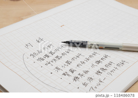 内科の種類を書き出している　原稿用紙に手書きでメモしている 118486078