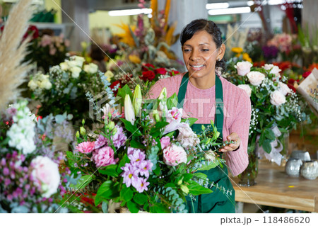 Latin woman florist working in floral shop Latin woman florist working in floral shop 118486620