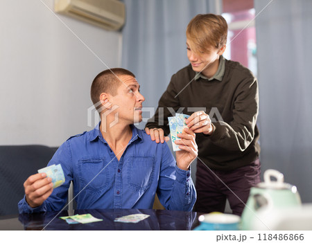 Father giving his teenage son pocket money 118486866