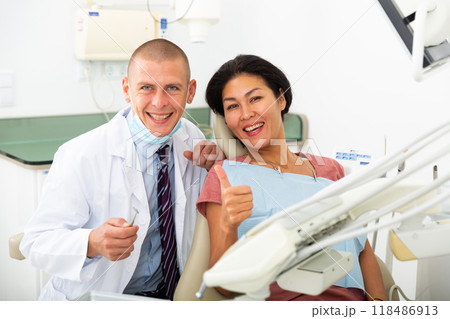 Satisfied patient visiting dentist giving thumbs up 118486913