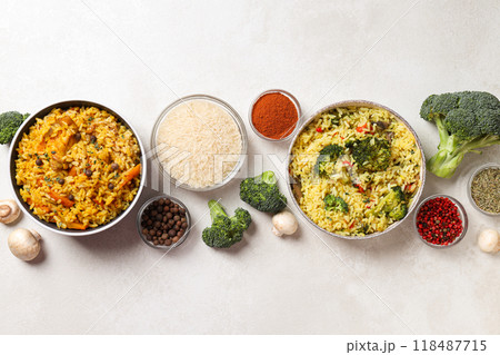 Pilaf, rice, spices in bowls and vegetables on light background, top view Pilaf, rice, spices in bowls and vegetables on light background, top view 118487715