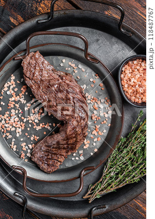 BBQ Grilled Machete or skirt beef meat steak in steel tray. Wooden background. Top view 118487767