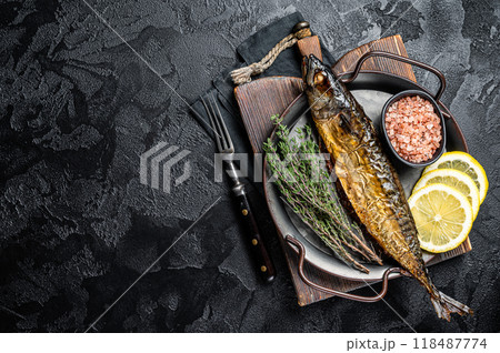 Baked Mackerel Scomber fish in steel tray with thyme and lemon. Black background. Top view. Copy space 118487774