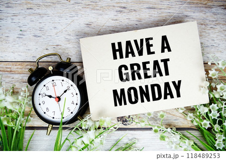 Have a great Monday text on paper card with alarm clock and flowers bouquet 118489253
