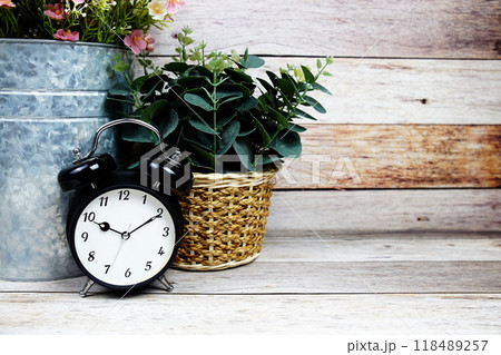 Vintage Alarm clock with space copy on wooden background Vintage Alarm clock with space copy on wooden background 118489257
