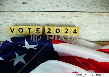 Vote 2024, Presidential Election with USA American flag on wooden background Vote 2024, Presidential Election with USA American flag on wooden background 118490149