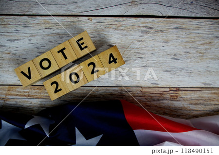 Vote 2024, Presidential Election with USA American flag on wooden background 118490151