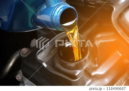 Refueling and pouring oil quality into the engine motor car Transmission and Maintenance Gear .Energy fuel concept. Refueling and pouring oil quality into the engine motor car Transmission and Maintenance Gear .Energy fuel concept. 118490687