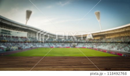 Stadium table background. Wooden table with blurred sports stadium background Stadium table background. Wooden table with blurred sports stadium background 118492768