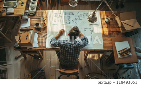 Architect at work at his desk in studio 118493053