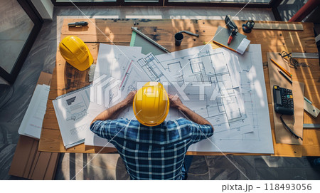 Architect at work at his desk in studio 118493056