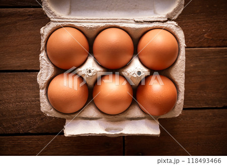 Egg box on a rustic wooden board Egg box on a rustic wooden board 118493466