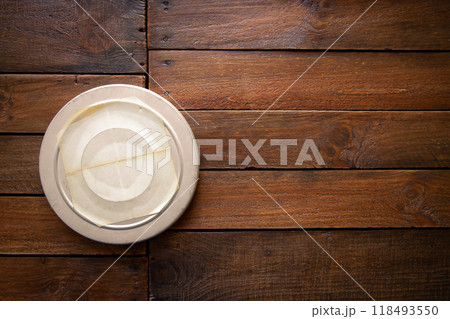 Old cinema film reel box on a rustic wooden board Old cinema film reel box on a rustic wooden board 118493550