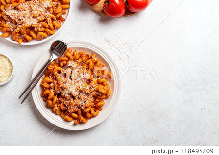 Cavatappi pasta with tomato sauce and grated parmesan cheese 118495209