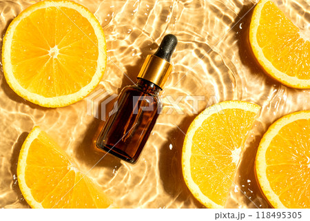 Face serum and orange citrus slices in water 118495305