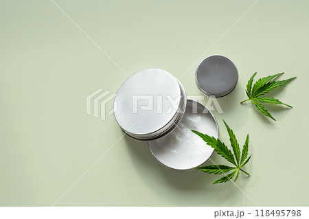 Hemp leaves and cosmetic jars with natural skincare products. Hemp leaves and cosmetic jars with natural skincare products. 118495798
