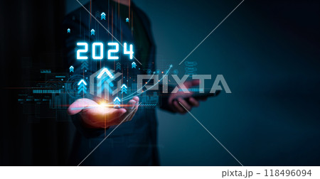 Businessman hand holding the increase arrow graph corporate future growth year 2023 to 2024. New Goals with Plans and Visions for Next Year 2024, Opportunity, challenge and business strategy. Businessman hand holding the increase arrow graph corporate future growth year 2023 to 2024. New Goals with Plans and Visions for Next Year 2024, Opportunity, challenge and business strategy. 118496094