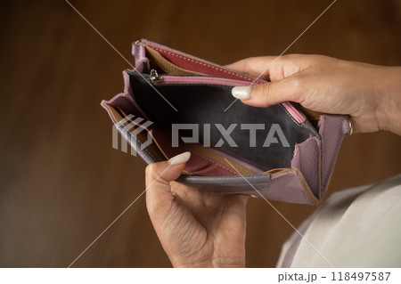 Woman presenting features of a small purple leather wallet Woman presenting features of a small purple leather wallet 118497587