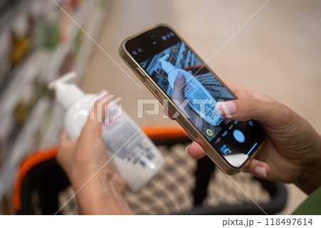 Woman taking pictures of cosmetic product with smartphone Woman taking pictures of cosmetic product with smartphone 118497614
