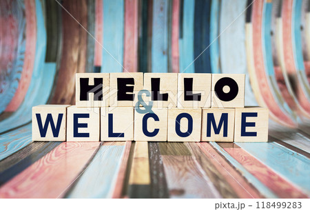 Symbol of greeting and greeting. Conceptual words "Hello" and "Welcome" on wooden blocks.  118499283