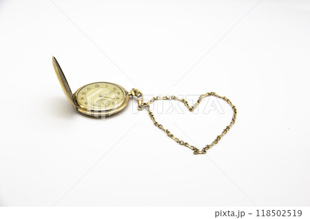 Vintage golden old pocket watch on white background. The chain lies in the form of a heart. Vintage golden old pocket watch on white background. The chain lies in the form of a heart. 118502519