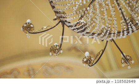 Elegant crystal chandelier hanging from ceiling in luxurious house 118502649