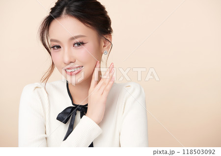 Beautiful young asian woman with clean fresh skin on beige background, Face care, Facial treatment, Cosmetology, beauty and spa, Asian women portrait. 118503092