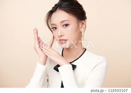 Beautiful young asian woman with clean fresh skin on beige background, Face care, Facial treatment, Cosmetology, beauty and spa, Asian women portrait. Beautiful young asian woman with clean fresh skin on beige background, Face care, Facial treatment, Cosmetology, beauty and spa, Asian women portrait. 118503107