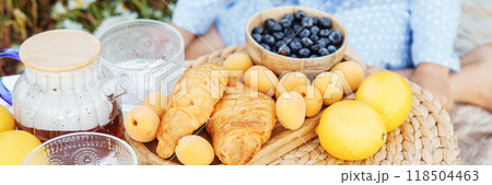 Picnic in the chamomile field. A large field of flowering daisies. The concept of outdoor recreation. Picnic in the chamomile field. A large field of flowering daisies. The concept of outdoor recreation. 118504463