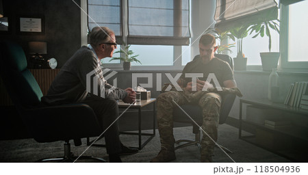 Senior psychiatrist gives antidepressants or sedative medicines to military man with PTSD Senior psychiatrist gives antidepressants or sedative medicines to military man with PTSD 118504936