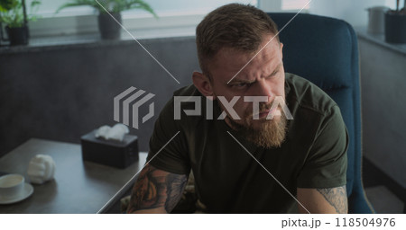 Portrait of military man with PTSD crying during psychotherapy session 118504976