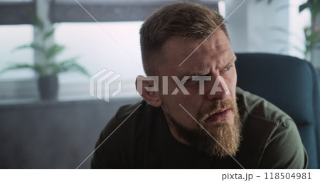 Close up of military man with PTSD crying, talking to psychotherapist Close up of military man with PTSD crying, talking to psychotherapist 118504981