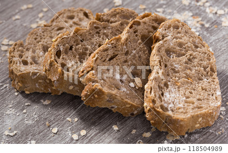 Fresh slices of rye bread on wooden surface 118504989