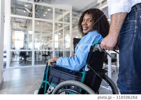 Female professional with disability working indoors from office 118506268