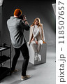 Capture professional photos in a studio setting with a female model for a photoshoot session 118507657