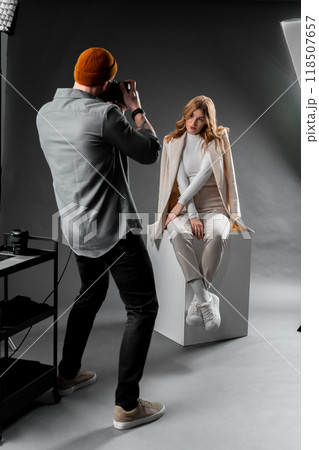Capture professional photos in a studio setting with a female model for a photoshoot session 118507657