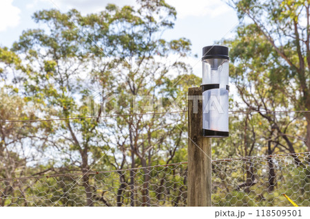 A rain gauge near a fence on a rural property A rain gauge near a fence on a rural property 118509501