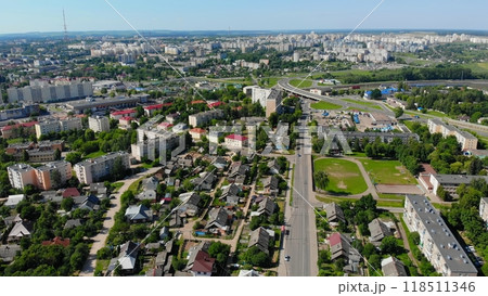Drone capturing modern city residential area with apartment buildings Lida city and private houses on a sunny summer day Drone capturing modern city residential area with apartment buildings Lida city and private houses on a sunny summer day 118511346