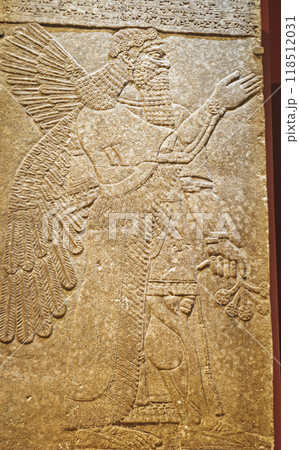 Winged Figure. Architectural Fragment Of Panel From Northwest Palace Of Ashurnasirpal Ii By Neo Assyrian Period. Depicted Is Winged Human Divine Spirit, Protective Spirit. Chosen Viceroy And High Winged Figure. Architectural Fragment Of Panel From Northwest Palace Of Ashurnasirpal Ii By Neo Assyrian Period. Depicted Is Winged Human Divine Spirit, Protective Spirit. Chosen Viceroy And High 118512031