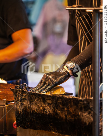 Food Vendor Preparing Food at Market 118513296