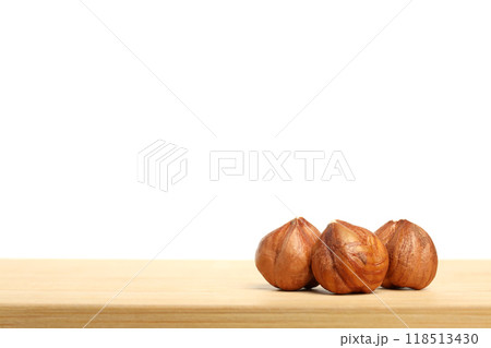PNG, Three whole hazelnuts on wooden table, isolated on white background, space for text PNG, Three whole hazelnuts on wooden table, isolated on white background, space for text 118513430