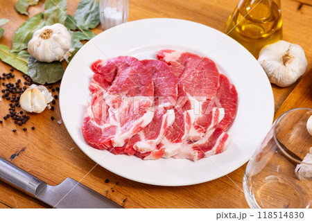 Fresh pork loin head slices on plate with condiments Fresh pork loin head slices on plate with condiments 118514830