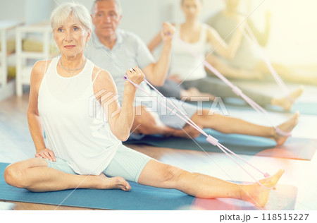 Elderly woman exercising with pilates loop 118515227