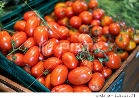 In warehouse of store - plastic boxes filled to top with ripe red tomatoes fruits. In warehouse of store - plastic boxes filled to top with ripe red tomatoes fruits. 118515371