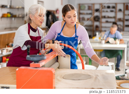women in pottery workshop work with roller press women in pottery workshop work with roller press 118515373