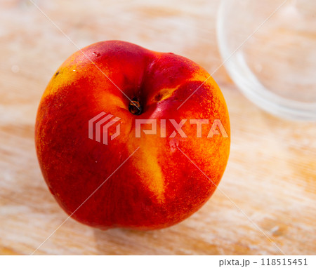 Ripe nectarine on plate with a knife. Tasty still life 118515451