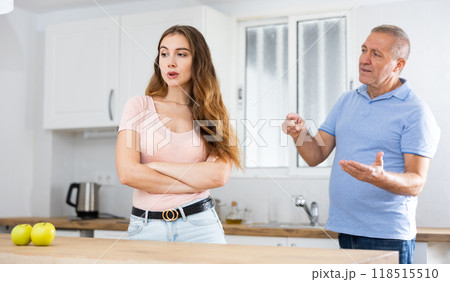 Daughter father scolding and yelling at her in home kitchen Daughter father scolding and yelling at her in home kitchen 118515510